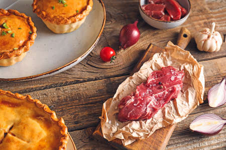 Tasty beef pot pies with meat on table