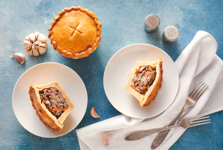 Tasty beef pot pies on color background