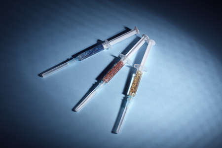 Syringes on color background. Concept of addiction to drugsの写真素材