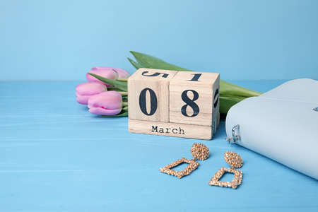 Calendar, flowers and accessories on color background. International Women's Day celebration