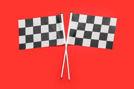 Racing flags on color background, top view