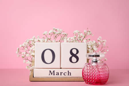 Calendar, flowers and perfume on color background. International Women's Day celebrationの写真素材