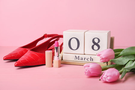 Calendar, flowers and accessories on color background. International Women's Day celebrationの写真素材