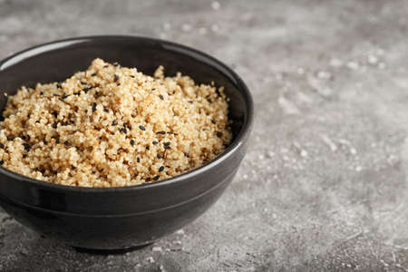 Bowl with tasty quinoa on gray background, closeupの写真素材