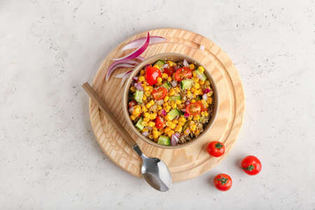 Composition with tasty quinoa salad on light backgroundの写真素材