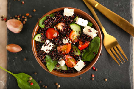 Bowl with tasty quinoa salad on dark backgroundの写真素材