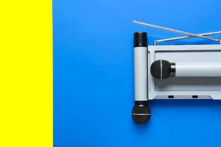 Modern microphones with audio system on color backgroundの写真素材
