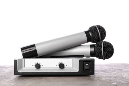 Modern microphones with audio system on white background