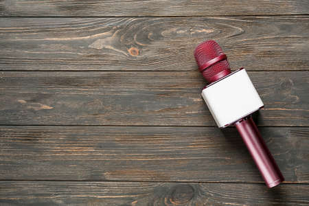 Modern microphone on wooden backgroundの写真素材