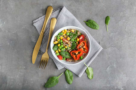 Bowl with healthy quinoa salad on grunge backgroundの写真素材