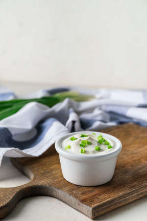 Bowl of tasty sour cream on tableの写真素材