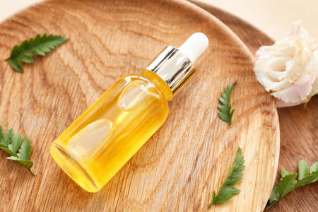 Bottle of healthy essential oil on plate, closeup