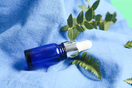 Bottle of healthy essential oil on clothの写真素材