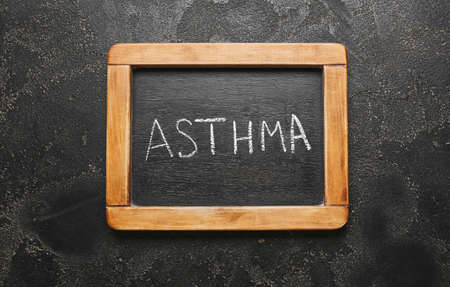 Chalkboard with text ASTHMA on dark backgroundの写真素材