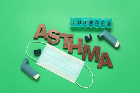 Inhalers, pills, medical mask and word ASTHMA on color backgroundの写真素材