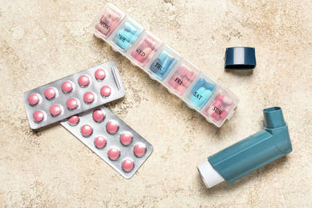 Modern inhaler and pills on grunge backgroundの写真素材