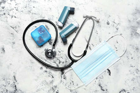 Inhalers, pills, medical mask and stethoscope on grunge backgroundの写真素材