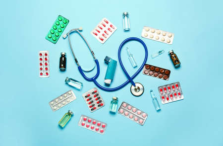 Inhaler, stethoscope and medicines on color backgroundの写真素材