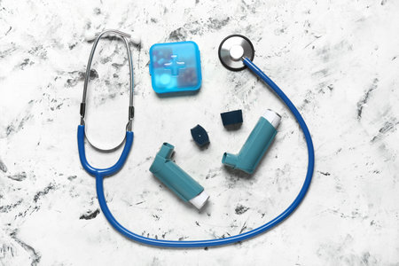 Modern inhalers, pills and stethoscope on grunge backgroundの写真素材