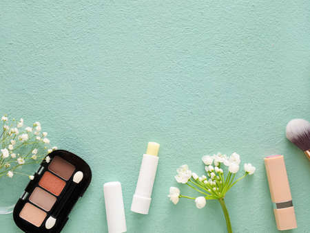 Cosmetics and spring flowers on color backgroundの写真素材