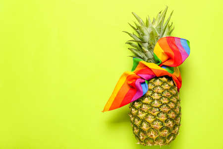 Fresh pineapple in kerchief on color backgroundの写真素材