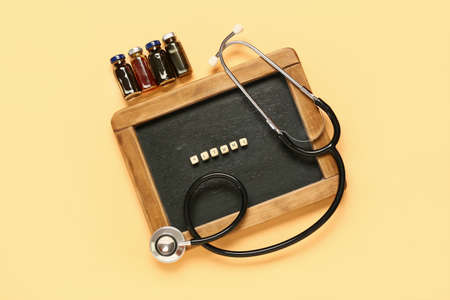 Chalkboard with word ASTHMA, ampules and stethoscope on color background