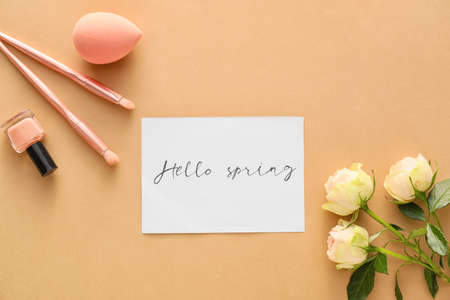 Composition with cosmetics and spring flowers on color backgroundの写真素材