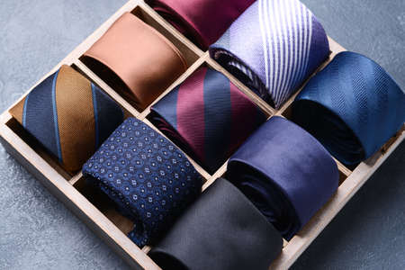Box with stylish neckties on dark backgroundの写真素材