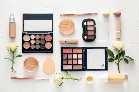 Cosmetics and spring flowers on light backgroundの写真素材