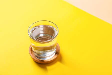 Glass of water on color backgroundの写真素材