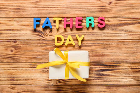Text FATHER'S DAY and gift box on wooden backgroundの写真素材