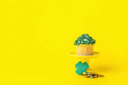 Tasty cupcake for St. Patrick's Day on color backgroundの写真素材