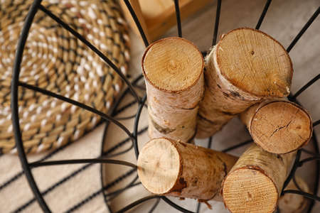 Stand with firewood on floor, closeup