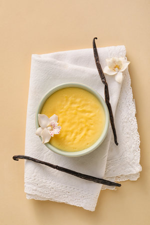 Ramekin with tasty vanilla pudding on color backgroundの写真素材