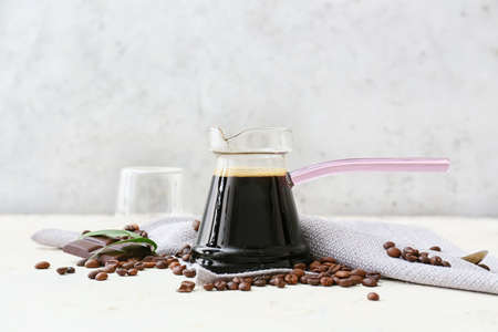 Composition with aromatic turkish coffee, chocolate and beans on light backgroundの写真素材