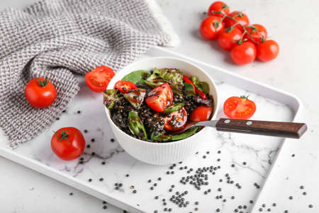 Bowl with tasty cooked lentils and vegetables on trayの写真素材