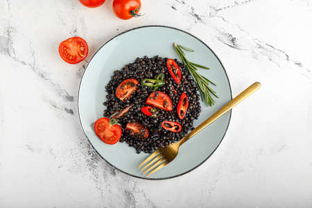 Plate with tasty cooked lentils and vegetables on white backgroundの写真素材