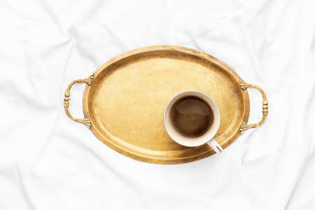 Tray with cup of coffee on bedの写真素材