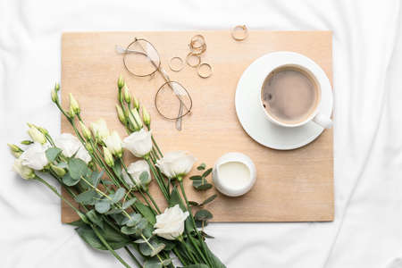 Composition with cup of coffee on bedの写真素材