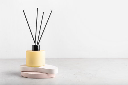 Reed diffuser on table against white background