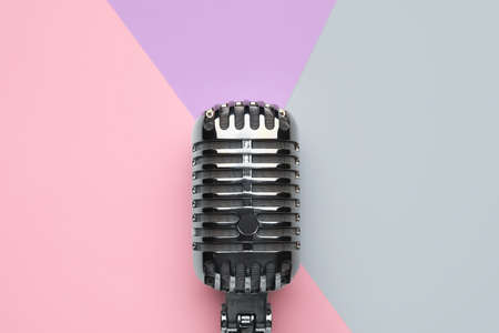 Retro microphone on color background, closeup