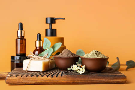 Composition with henna powder and cosmetics on color backgroundの写真素材