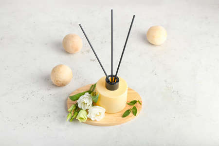 Reed diffuser with eustoma on white background
