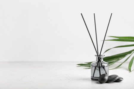 Reed diffuser with tropical leaf and spa stones on white backgroundの写真素材