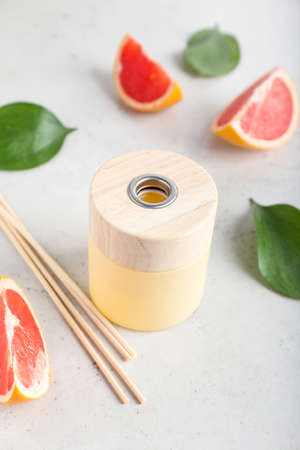 Reed diffuser with grapefruit on light backgroundの写真素材