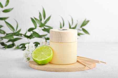 Reed diffuser with lime and flowers on light backgroundの写真素材