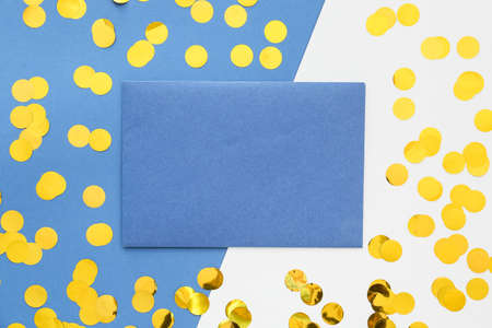 Blank paper sheet and confetti on color backgroundの写真素材