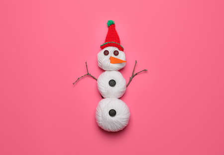 Funny snowman made of threads on color backgroundの写真素材