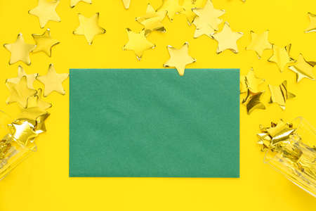 Blank paper sheet and confetti on color background