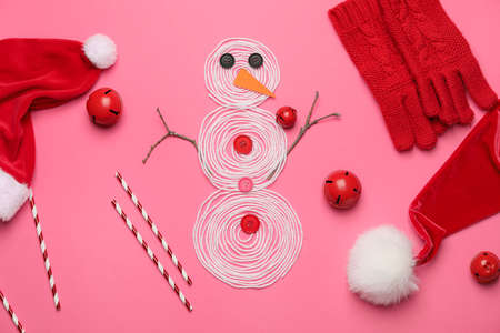 Christmas composition with snowman and decor on color backgroundの写真素材